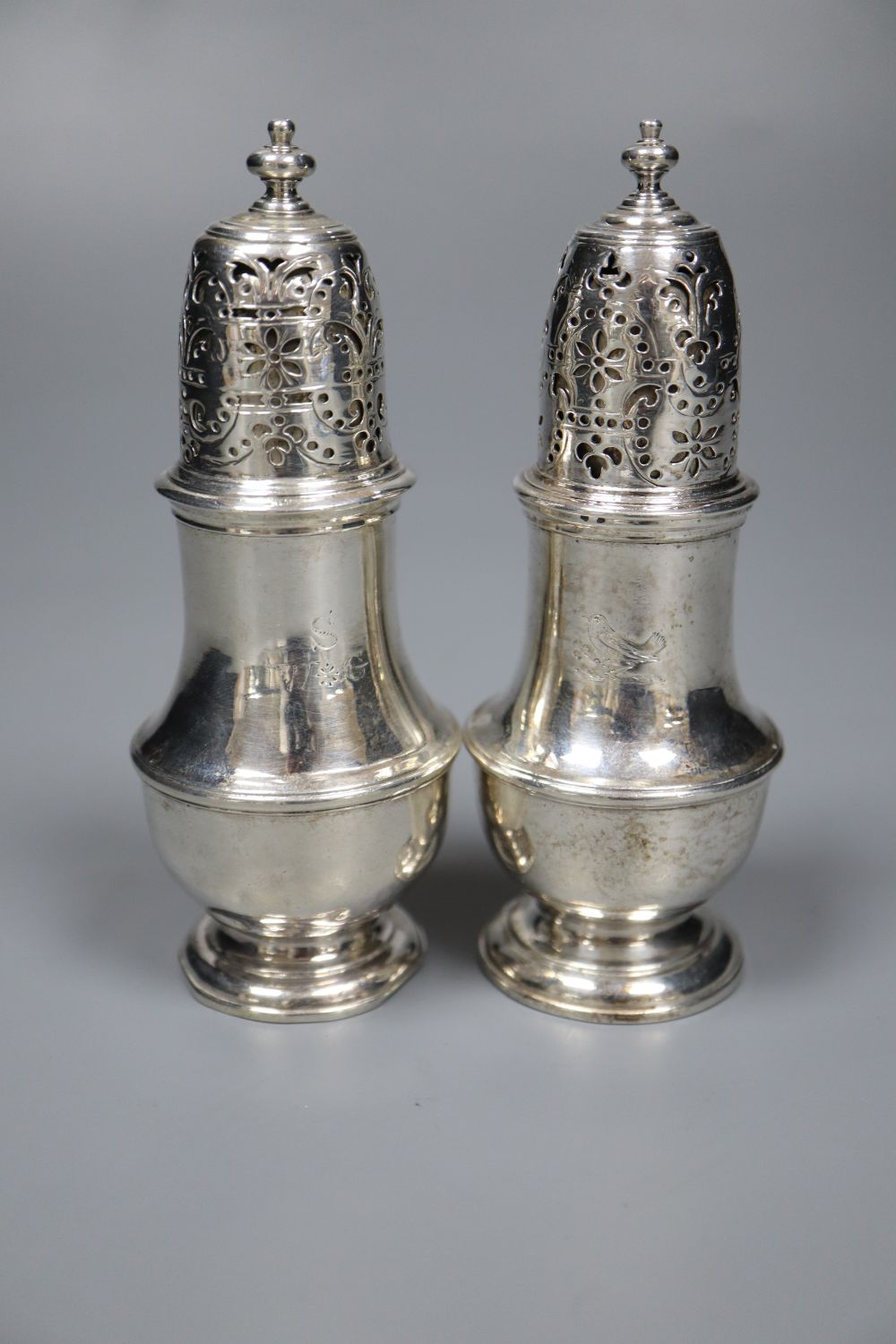 A matched pair of George I and George II silver pepperettes, Thomas Bamford, London, 1723 & 1728,